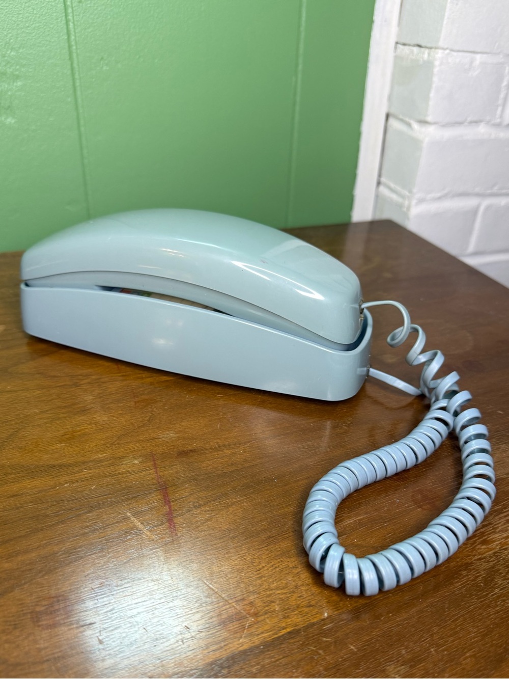 vintage AT&T Trimline wall/desk phone in a light blue